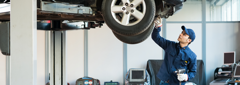 Service technician working on a vehicle's suspension system